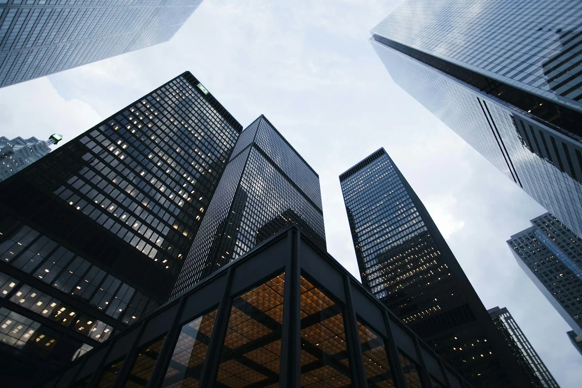 Modern financial-district towers viewed from below, representing global institutional capital markets